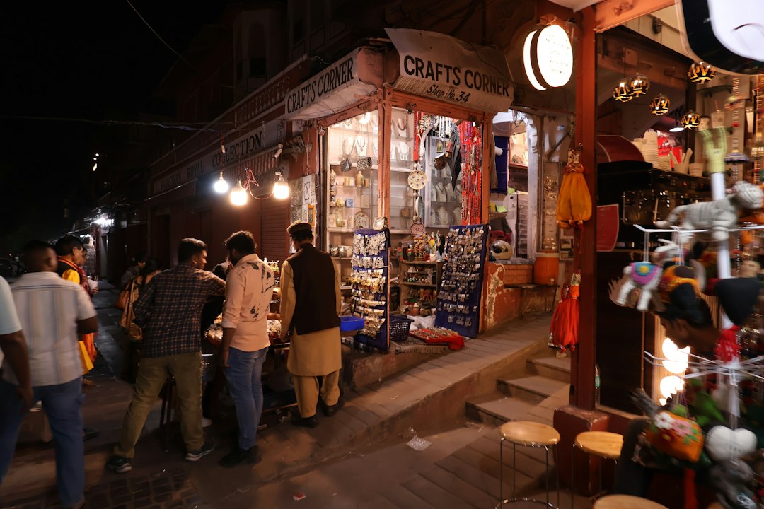 People browse shops on a street at night